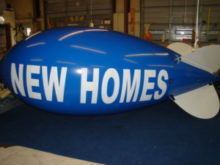 advertising-blimp-New-Homes-lettering-300x225.jpeg